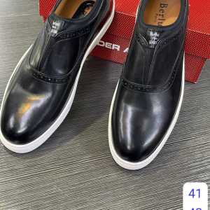 premium black Berluti slip‑on sneakers,